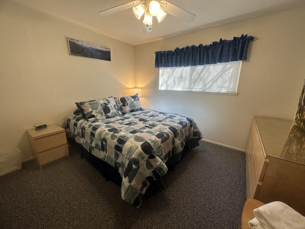 Second downstairs queen bedroom with July 2023 geometric bedding